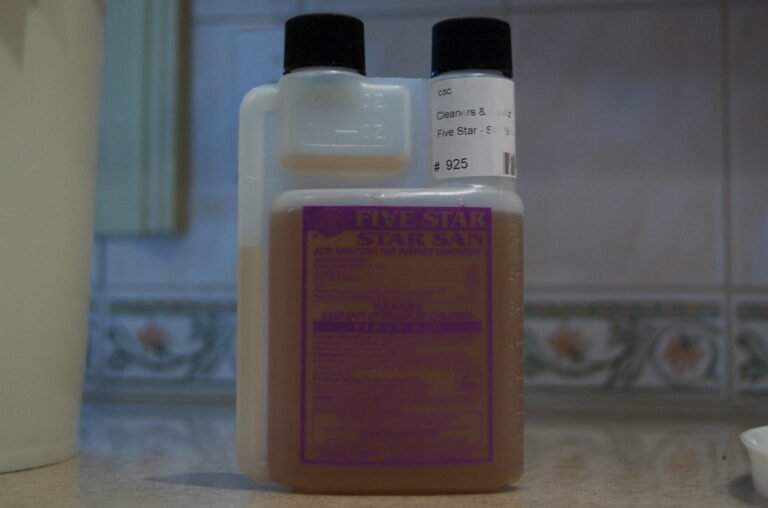 Three bottles of Five Star cleaning and sanitizing products on a kitchen countertop, with a focus on the front purple-labeled bottle.